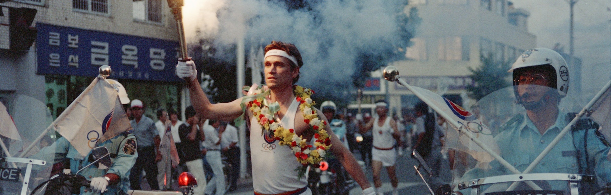 Lawrence Mac Donald holds the olympic flame in the streets of Seoul on August 30, 1988. (Photo by - ...
