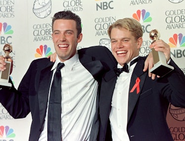 Actor Matt Damon (R) and co-writer Ben Affleck (L)  pose with their Golden Globe award for Best Scre...