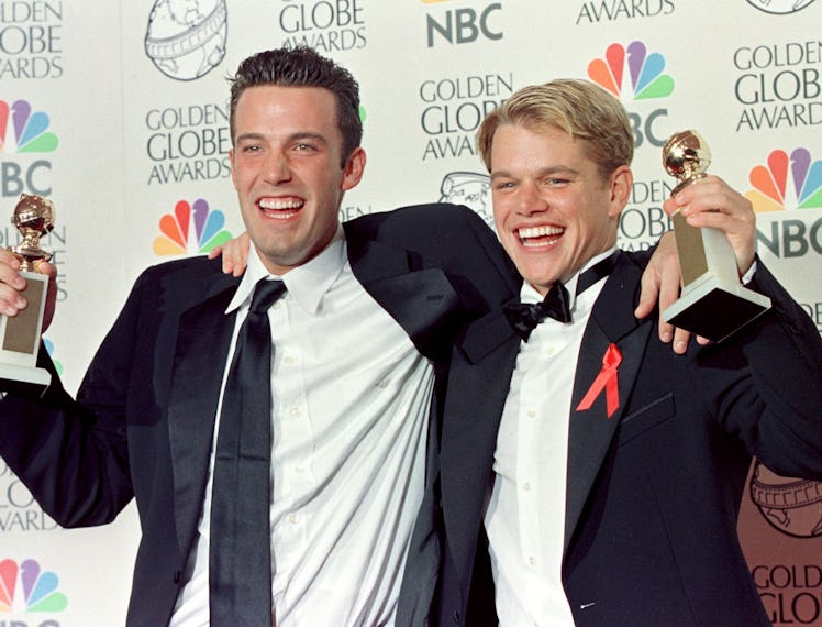 Actor Matt Damon (R) and co-writer Ben Affleck (L) pose with their Golden Globe award for Best Scre...