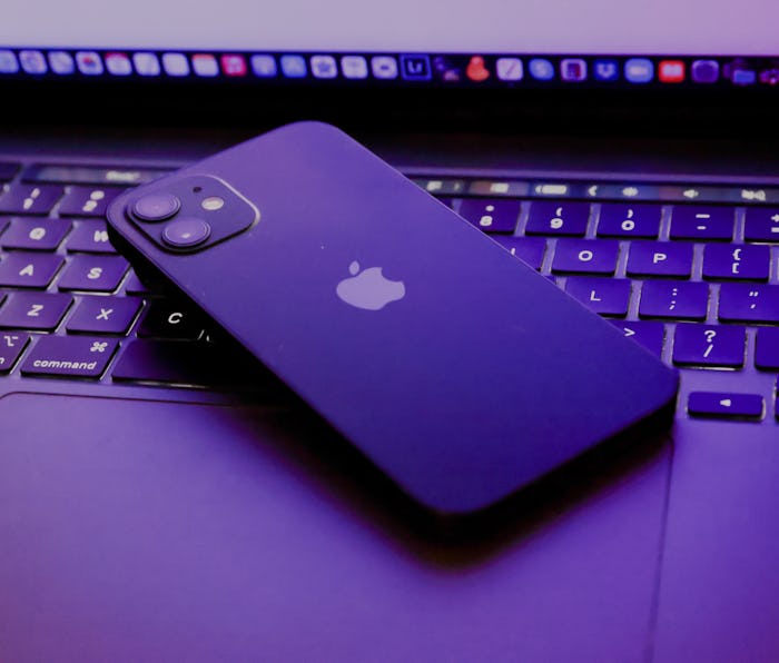 TOKYO, JAPAN - 2021/06/06: In this photo illustration, Apples iPhone 12 seen placed on a MacBook Pro...