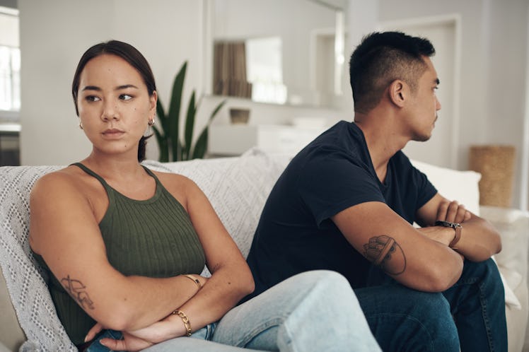 A girlfriend who is always picking fights with her boyfriend sits quietly next to him.