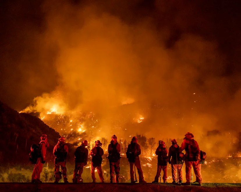 MOUNTAIN HOME VILLAGE, CALIFORNIA - September 9: A group of inmate firefighter watch as the El Dorad...