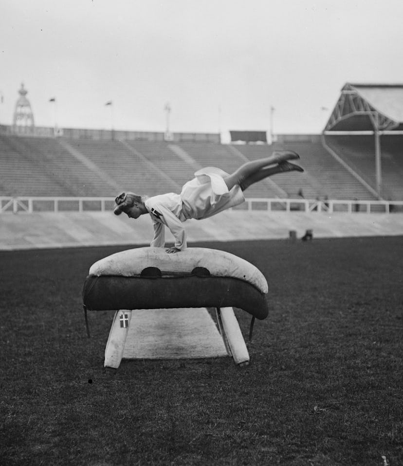 July 1908: A Danish gymnast performing on a gymnastic pommel horse at the 1908 London Olympics. (P...