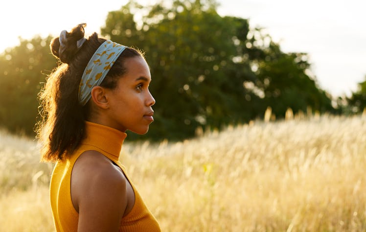 Young woman surrounded by wheat, having the worst week of August 2, 2021 per her zodiac sign.