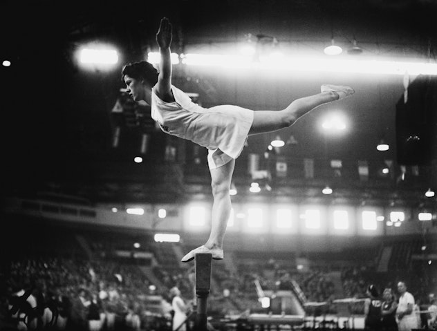 Cissie Davies of Great Britain on the balance beam at Empress Hall, Earl's Court, during the gymnast...