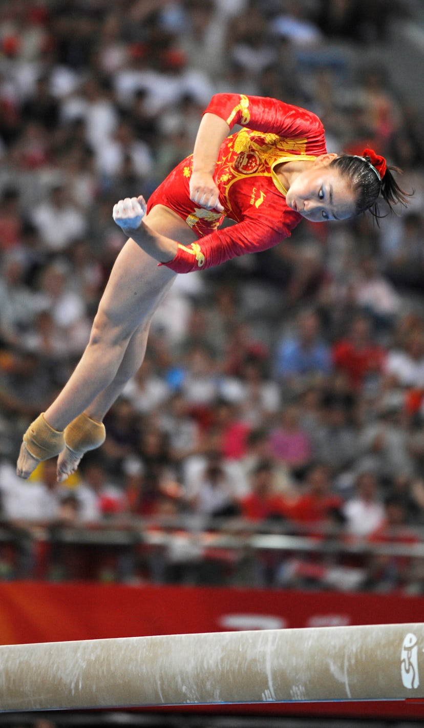 China's Shanshan Li competes on the balance beam during the women's team final of the artistic gymna...