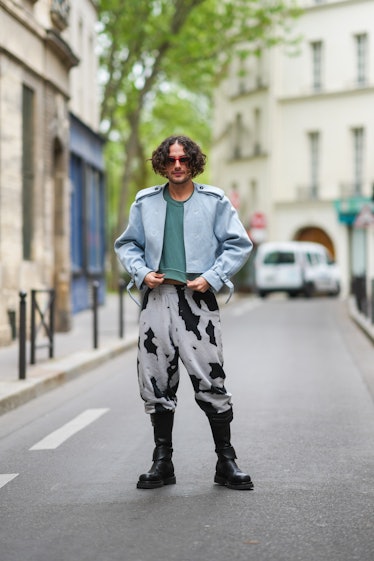Alejandro Acero demonstrates how to wear combat boots with statement tie-dye sweatpants, a green shi...
