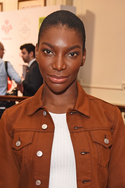 Michaela Coel, Aneka in 'Black Panther: Wakanda Forever.' in a brown denim jacket and a white ribbed...