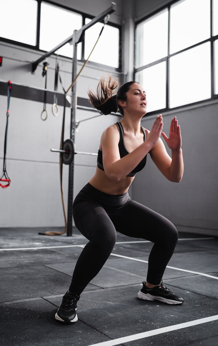 Get low in a classic squat, aka the most fundamental glute exercise.
