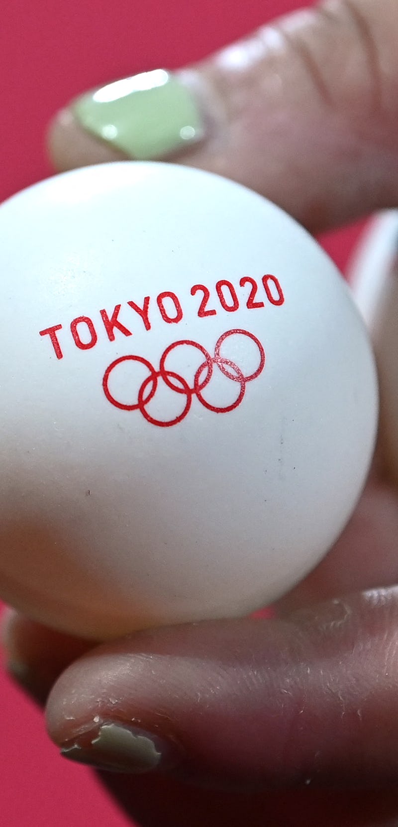 Portugal's Jieni Shao shows the Tokyo 2020 logo on a ball during a table tennis training session at ...