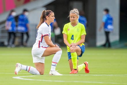 TOKYO, JAPAN - JULY 21:  Alex Morgan. #13 of the United States and Hanna Glas #4 of Sweden take a kn...
