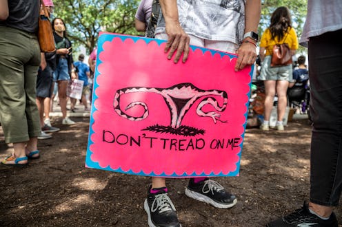 A protester holds a "Don't Tread On Me" sign at a pro-abortion protest. Advocates share ways to help...