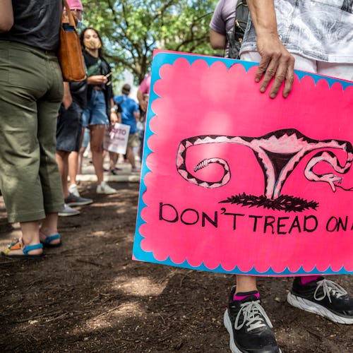 A protester holds a "Don't Tread On Me" sign at a pro-abortion protest. Advocates share ways to help...