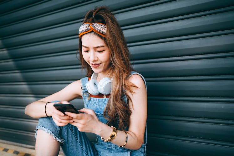 A woman smiles after realizing her crush watched her Instagram Stories.