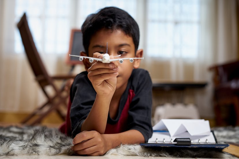 Boy making paper airplanes.