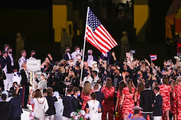 TOKYO, JAPAN - JULY 23: Flag bearers Sue Bird and Eddy Alvares of Team United States lead their team...