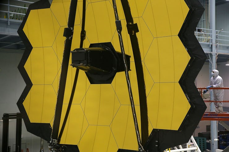 GREENBELT, MD - NOVEMBER 02:  A technician stands next to the James Webb Space Telescope during asse...
