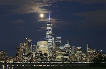 JERSEY CITY, NJ - JULY 22: The Buck Moon rises behind lower Manhattan and One World Trade center a day before being full in New York City on July 22, 2021 as seen from Jersey City, New Jersey. (Photo by Gary Hershorn/Getty Images)