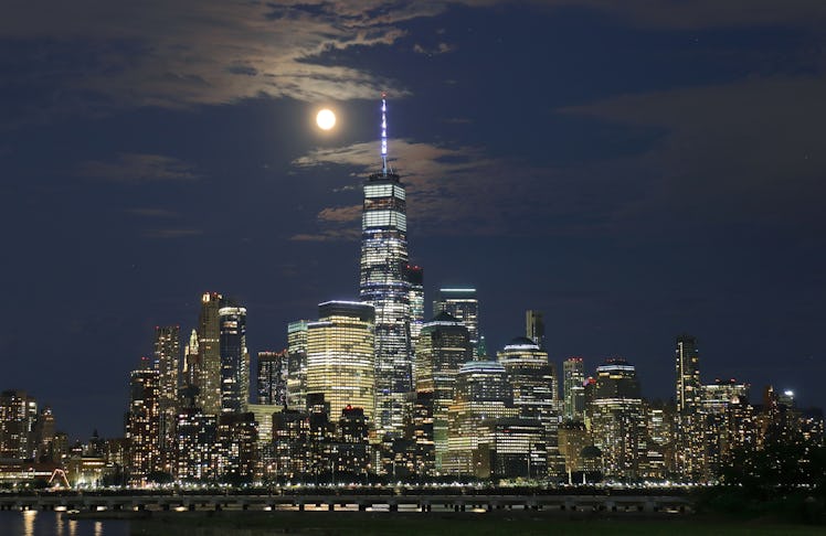 JERSEY CITY, NJ - JULY 22: The Buck Moon rises behind lower Manhattan and One World Trade center a d...