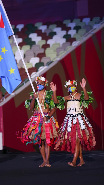 TOKYO, JAPAN - JULY 23: Flag bearers Matie Stanley and Karalo Hepoiteloto Maibuca of Team Tuvalu dur...