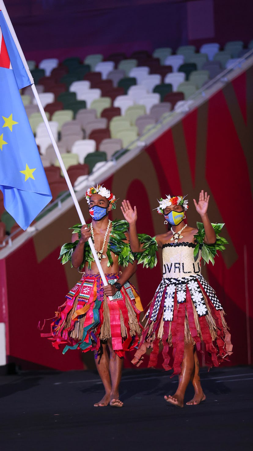 TOKYO, JAPAN - JULY 23: Flag bearers Matie Stanley and Karalo Hepoiteloto Maibuca of Team Tuvalu dur...