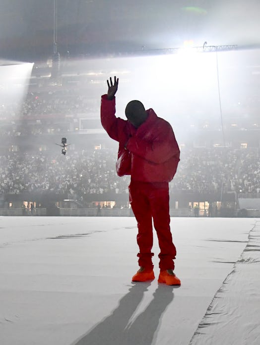 Kanye West, shown here at the 'Donda' listening party in a red outfit, faked out his fans again. 