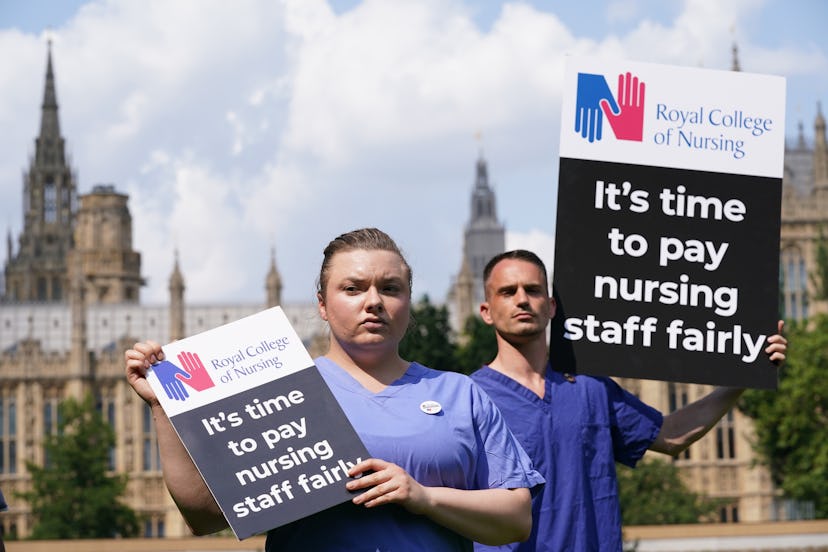 Nurses with placards outside the Royal College of Nursing (RCN) in Victoria Tower Gardens, London, f...