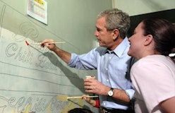 WASHINGTON - JANUARY 15:  (AFP OUT) U.S. President George W. Bush helps paint a mural along side Cit...