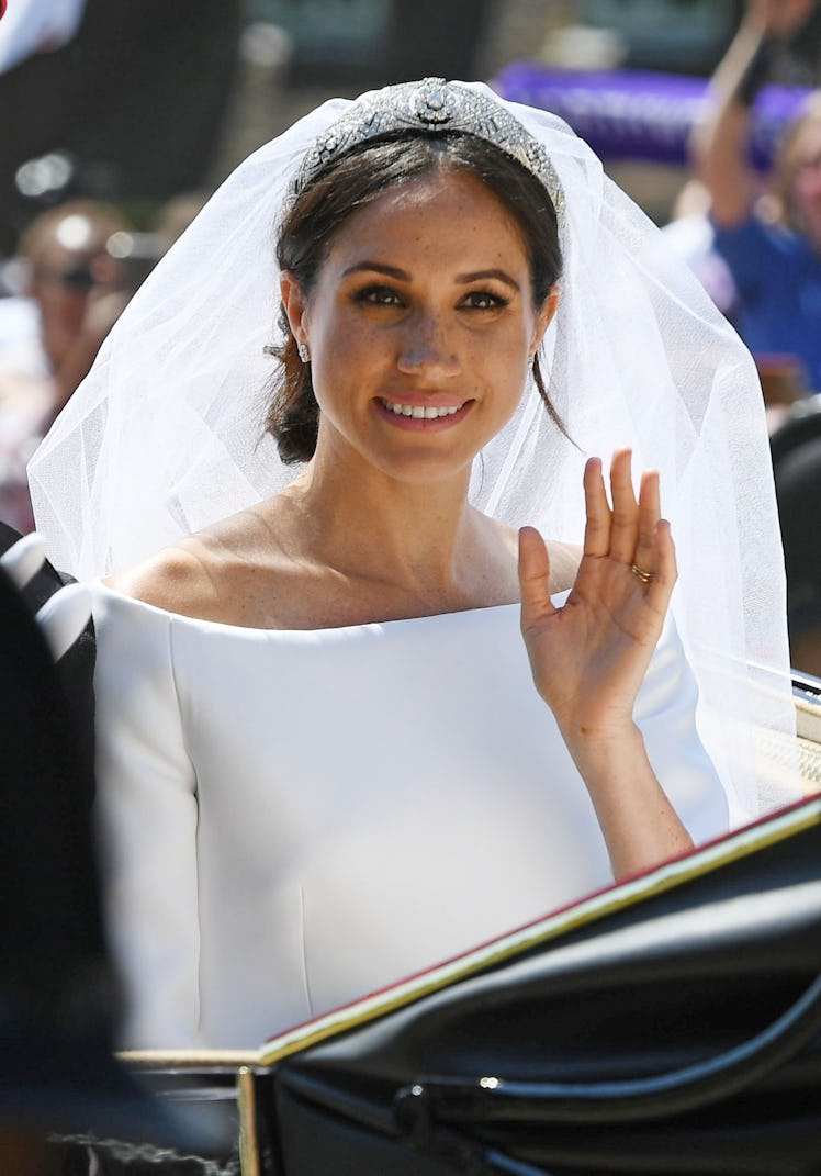 Meghan, the Duchess of Sussex, is shown here on her wedding day in a white off the shoulder dress, v...