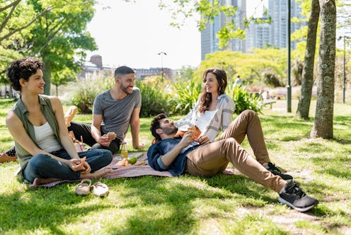 Friends on the lawn of the public park in Puerto Madero, Buenos Aires, Argentina