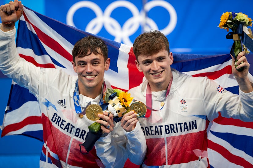 TOKYO, JAPAN - JULY 26: (BILD ZEITUNG OUT) Matty Lee and Thomas Daley of Great Britain celebrate wit...