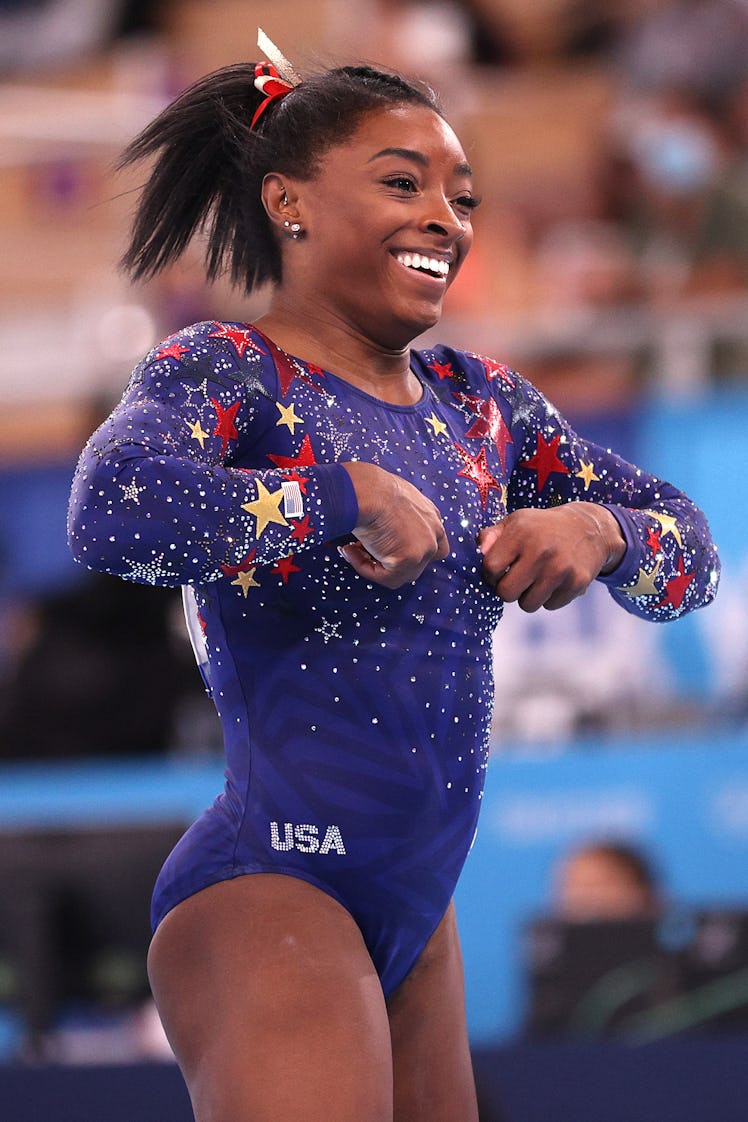 TOKYO, JAPAN - JULY 25: Simone Biles of Team United States reacts after competing on balance beam du...
