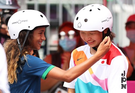 TOKYO, JAPAN - JULY 26: Rayssa Leal of Team Brazil puts her hand up to the face of Momiji Nishiya o...