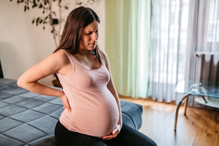 Young pregnant woman having heartburn in the last trimester of pregnancy.