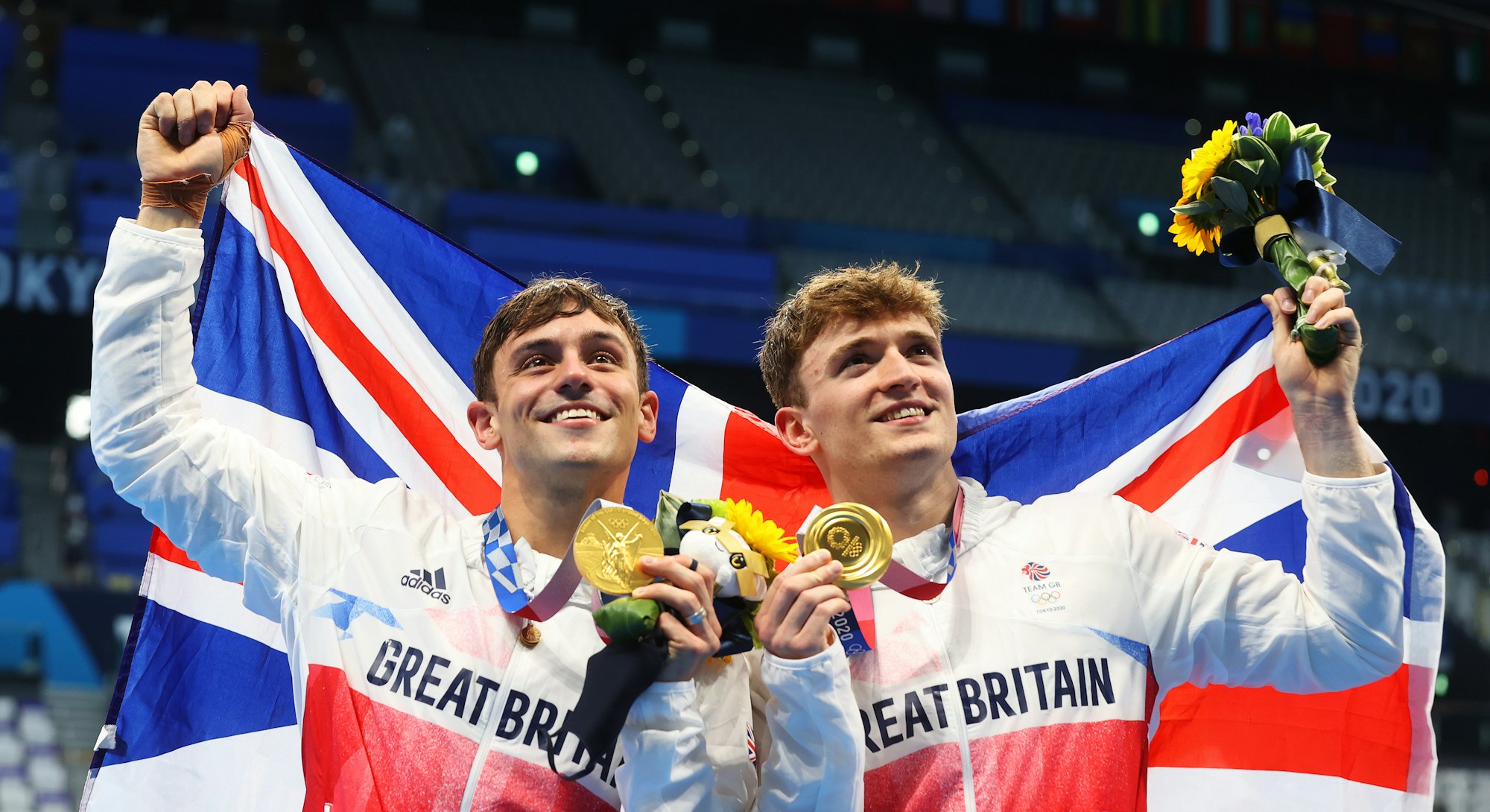 Tom Daley and Matty Lee of Team Great Britain pose for photographers with their gold medals after wi...
