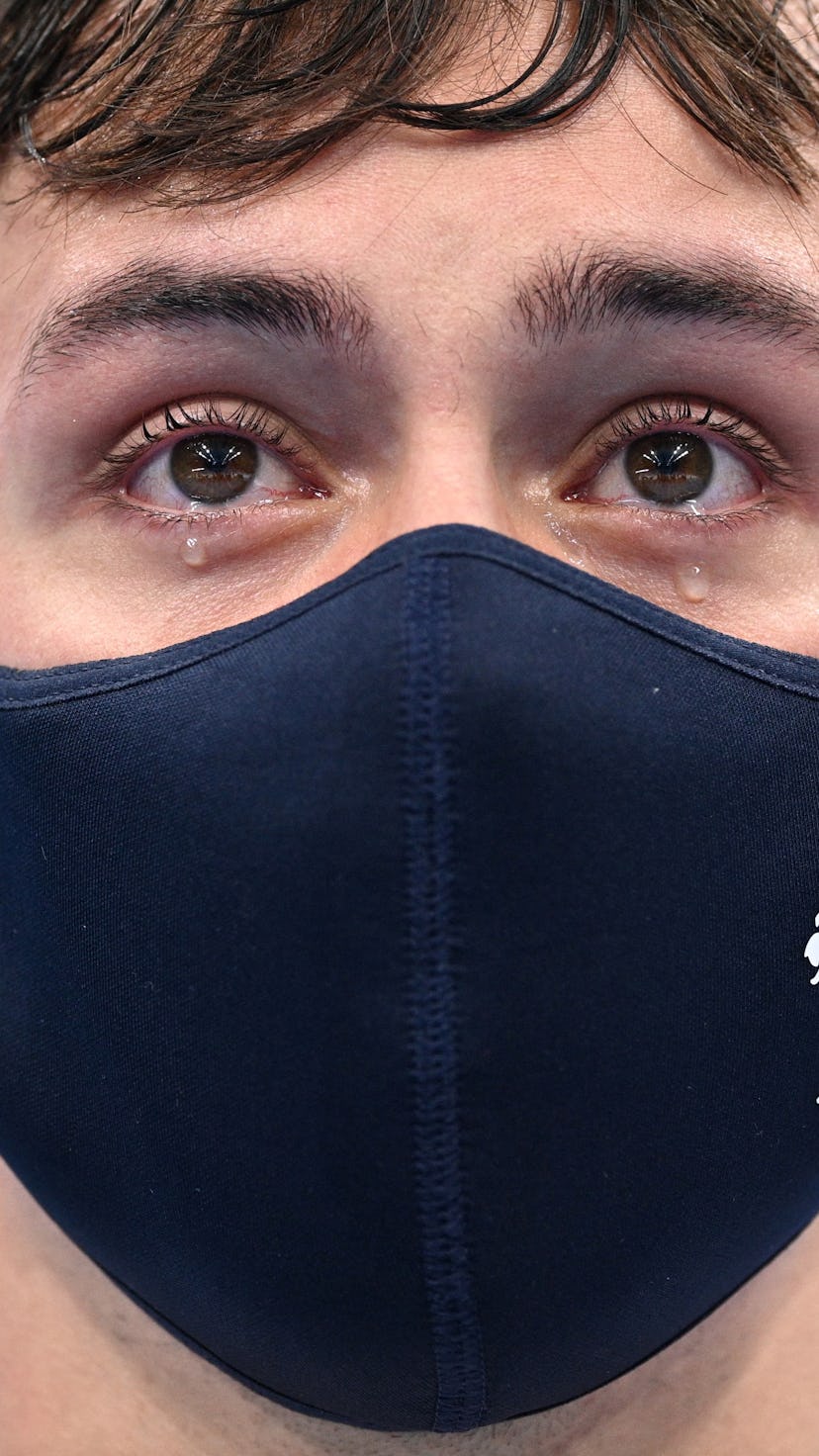 Tears well in the eyes of gold medallists Britain's Thomas Daley and Britain's Matty Lee (unseen) as...