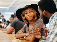 Young trendy ethnic African couple eating Chinese Food in trendy market in Braamfontein Johannesburg...