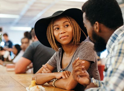 Young trendy ethnic African couple eating Chinese Food in trendy market in Braamfontein Johannesburg...