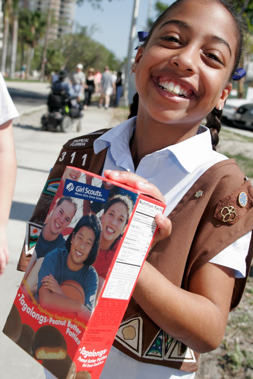 Girl Scout selling cookies. 
