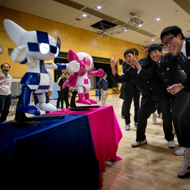 Schoolchildren interact with Tokyo 2020 Olympic and Paralympic Games' robot-type mascots Miraitowa a...