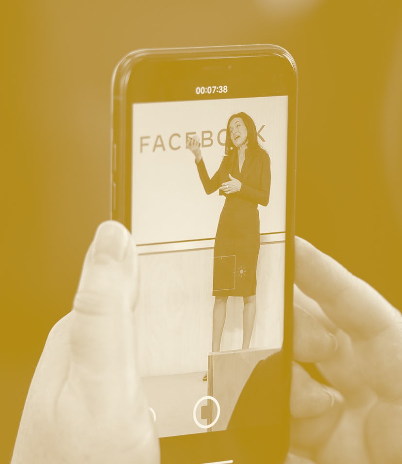 Facebook's Chief Operating Officer Sheryl Sandberg is displayed on the screen of a smartphone as she...