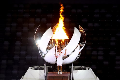 Naomi Osaka of Japan stands with the Olympic flame during the Opening Ceremony of the Tokyo 2020 Oly...