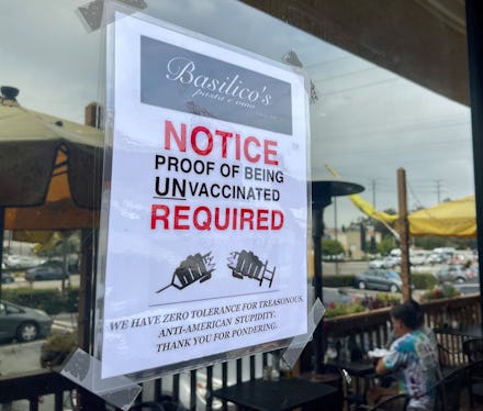 HUNTINGTON BEACH, CA - JULY 26: Signs at Basilicos Pasta e vino encourage people without the COVID-1...