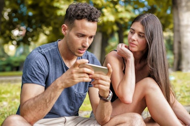 Mistrust in Couple due to Jealousy. Woman Spying on her Boyfriend's Phone