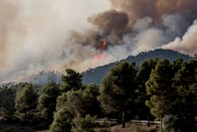 Firefighters and volunteers are working to stop the wildfire in the counties of Anoia and Conca de B...