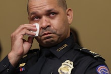 WASHINGTON, DC - JULY 27: U.S. Capitol Police officer Sgt. Aquilino Gonell becomes emotional as he t...