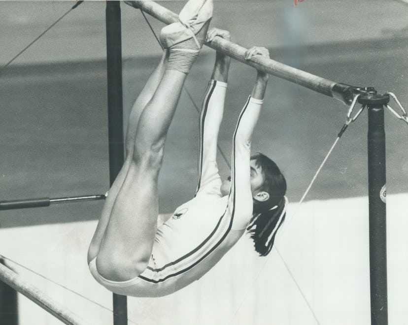 Romanian gymnast Nadia Comaneci on the parallel bars. Why are gymnasts so short?