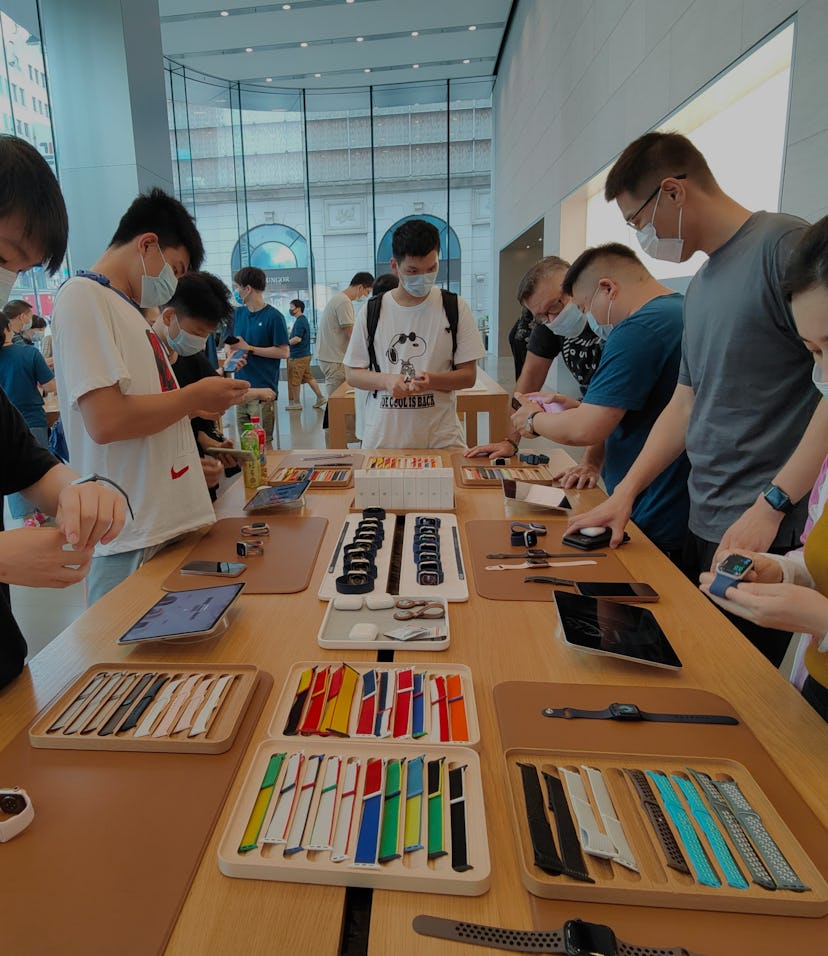 SHANGHAI, CHINA - JULY 2, 2021 - Consumers pick up a trial of Apple Watch Series 6 and Apple Watch S...