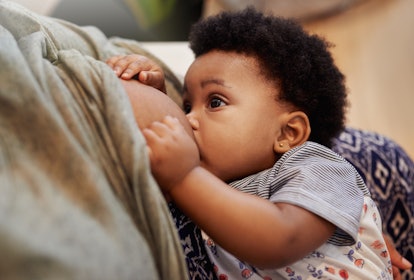 Cropped shot of a mother breastfeeding her baby girl