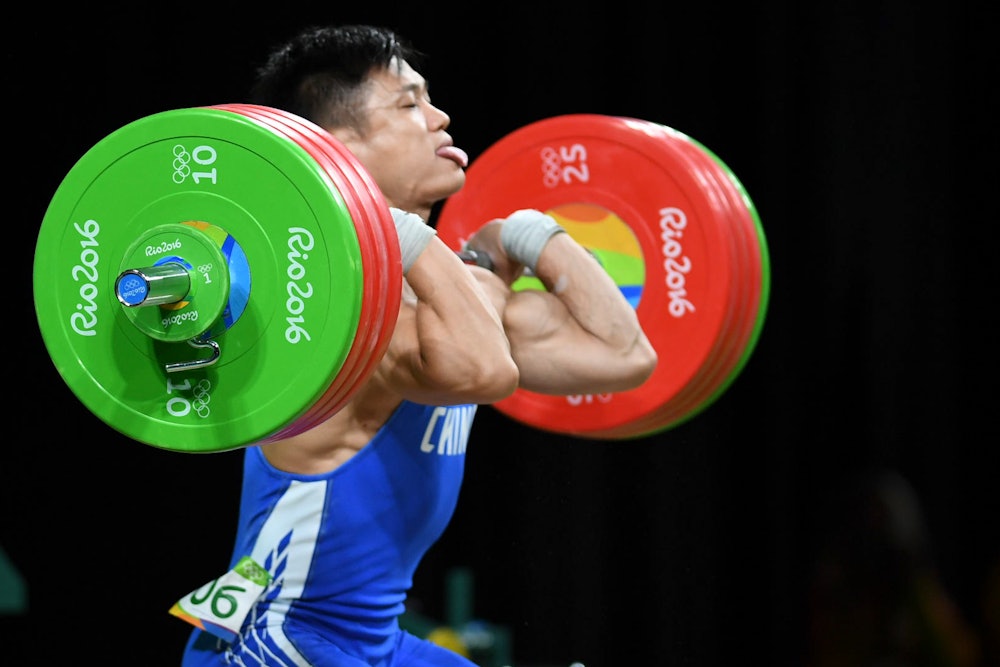 RIO DE JANEIRO, BRAZIL - AUGUST 10: Lyu Xiaojun of China competes during the Men's 77kg weightlifti...